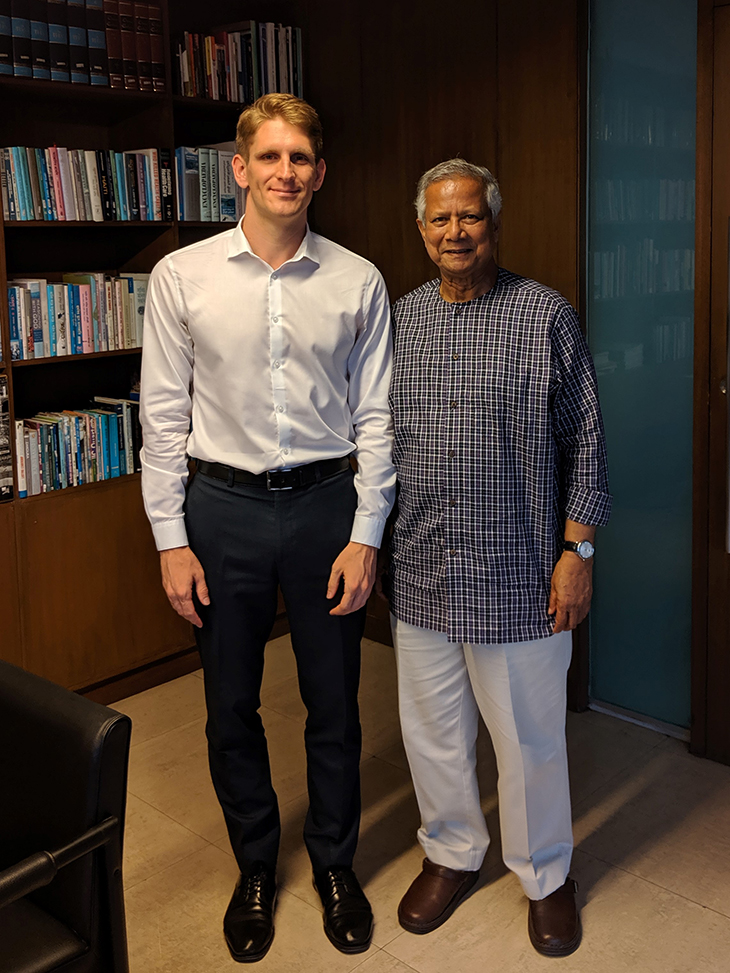 A man and Yunus standing next to each other